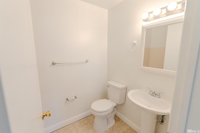 bathroom with sink, tile patterned floors, and toilet