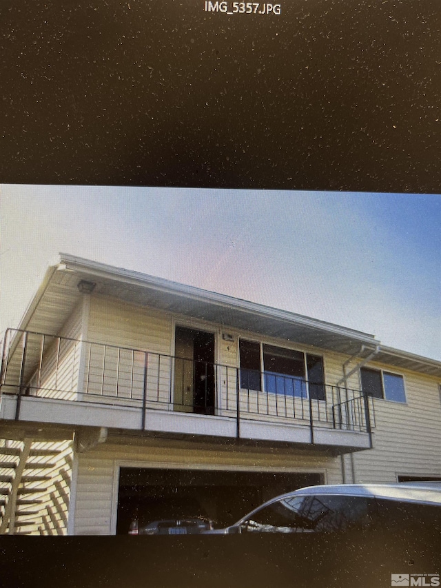 view of front of house featuring a balcony