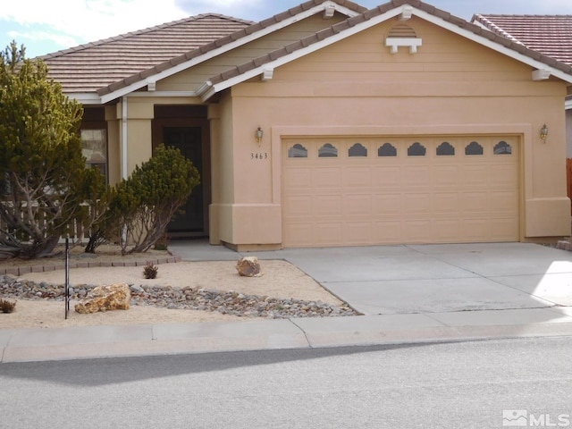 single story home featuring stucco siding, driveway, a tile roof, and an attached garage