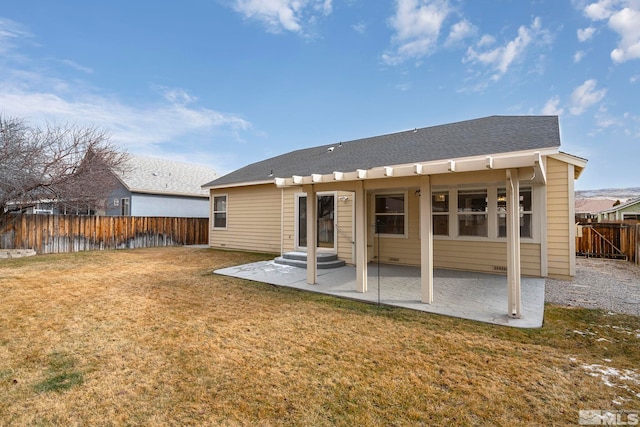 back of house featuring a yard and a patio area