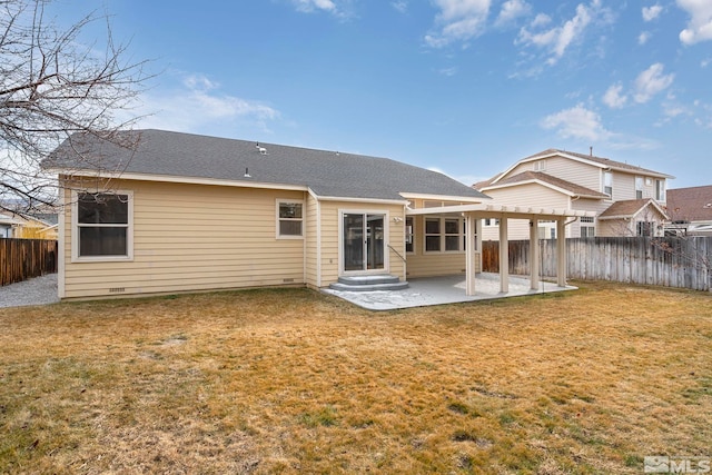 rear view of house with a patio and a lawn