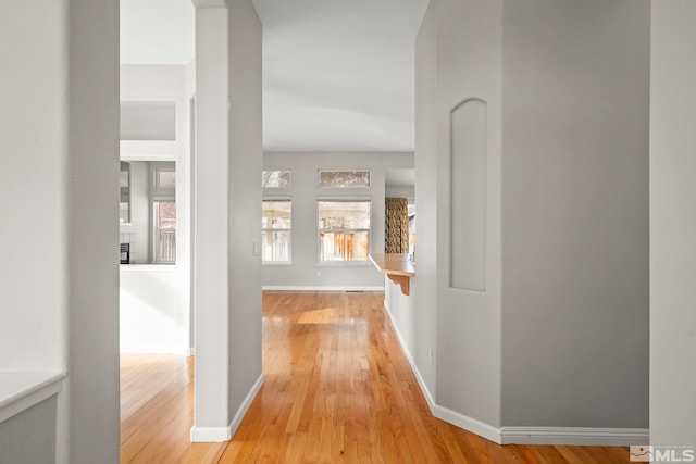 corridor with light wood-type flooring