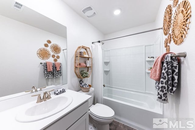 full bathroom with vanity, hardwood / wood-style floors, shower / bath combination with curtain, and toilet