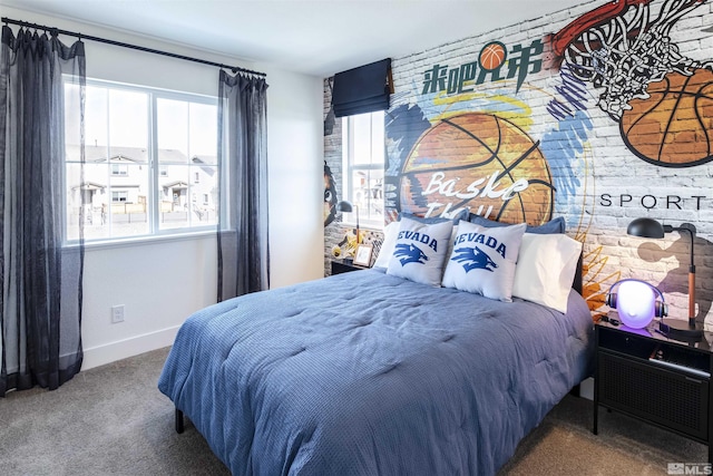 carpeted bedroom with brick wall