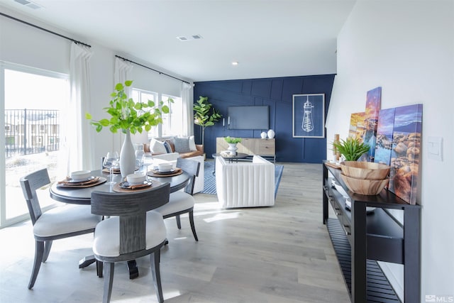 dining space with light hardwood / wood-style flooring