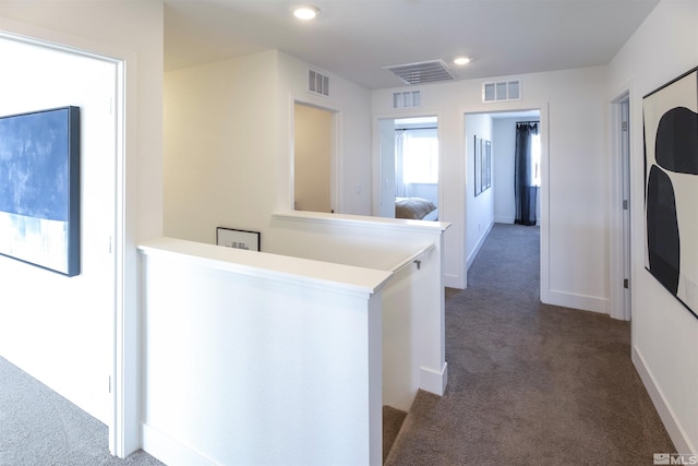 corridor with dark colored carpet