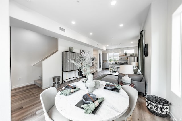 dining space with hardwood / wood-style flooring