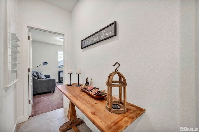 hallway featuring light tile patterned flooring