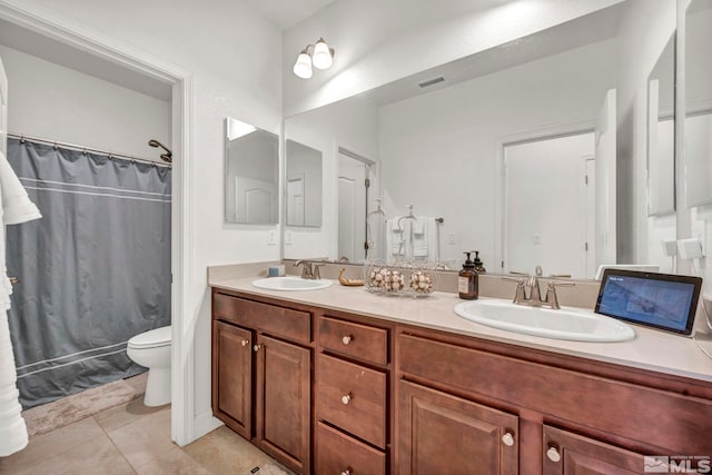 bathroom with vanity, toilet, and tile patterned flooring