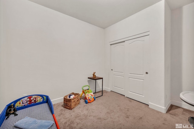 recreation room featuring light colored carpet