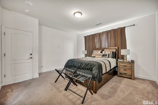 bedroom featuring light carpet