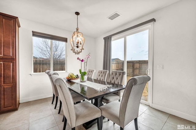 dining room featuring an inviting chandelier and light tile patterned floors