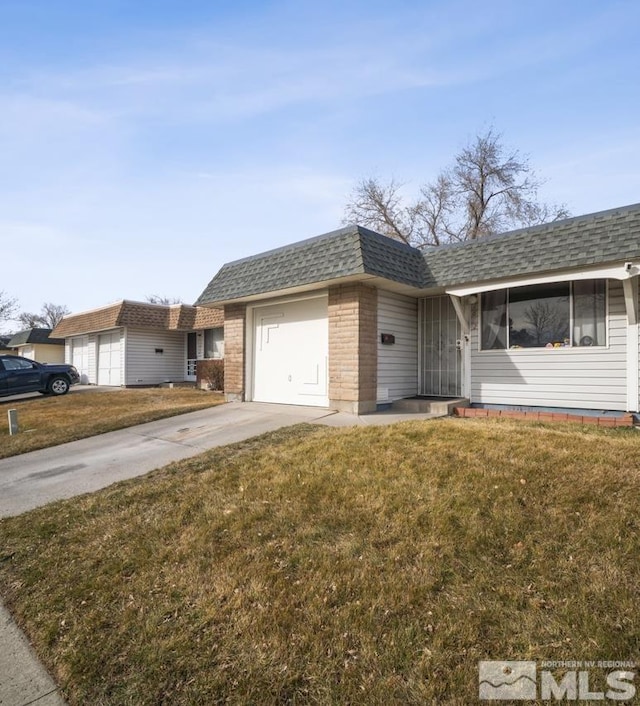 single story home with a garage and a front lawn