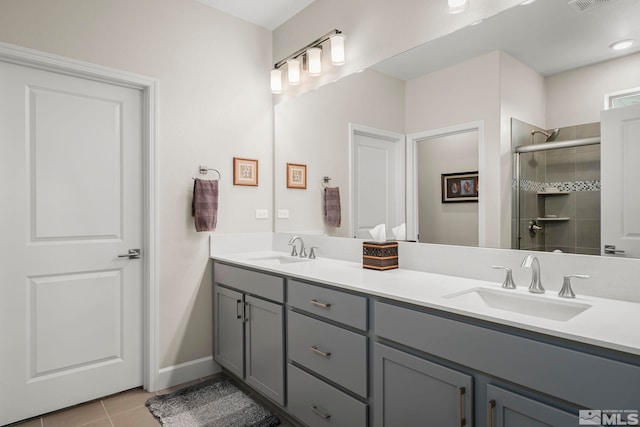 bathroom with walk in shower, tile patterned floors, and vanity