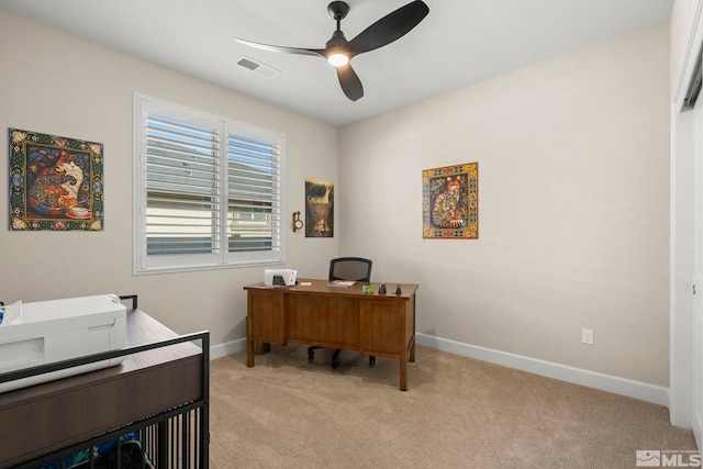 home office with light carpet and ceiling fan