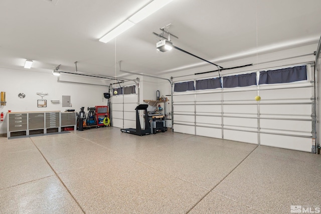 garage with a garage door opener and electric panel