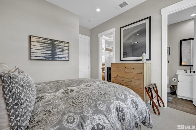 bedroom featuring carpet and connected bathroom