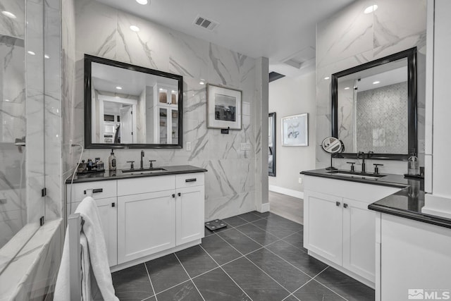 bathroom featuring vanity and tile walls