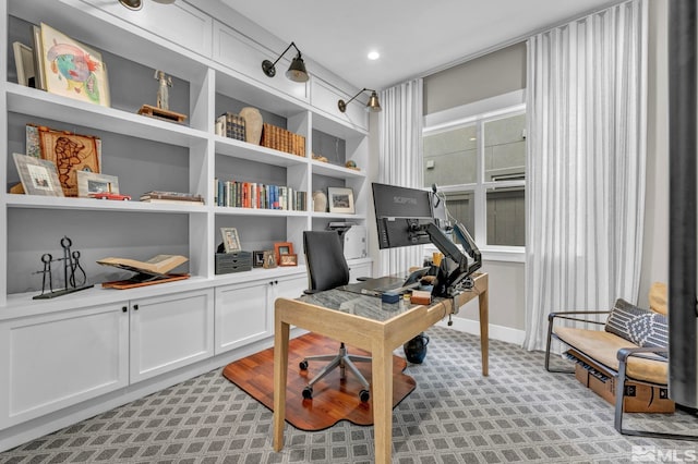 home office with built in features and light colored carpet