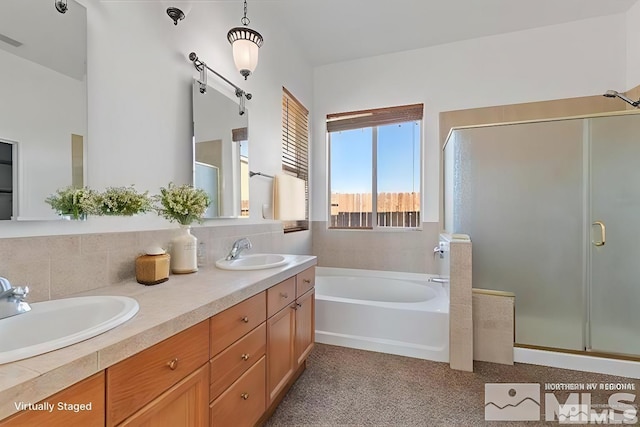 bathroom featuring vanity and shower with separate bathtub