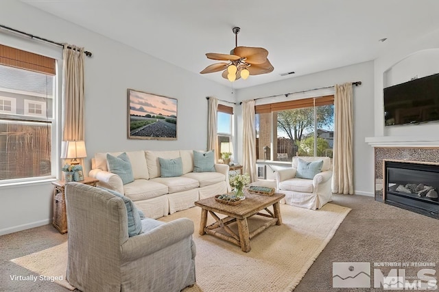 living room with ceiling fan and carpet