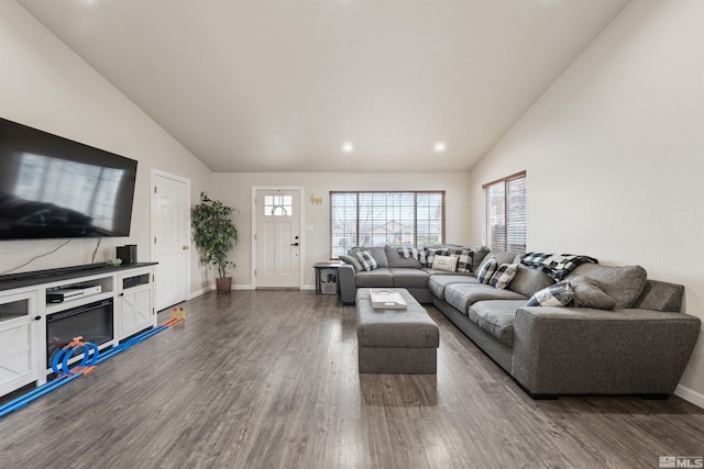 living room with dark wood-type flooring and high vaulted ceiling