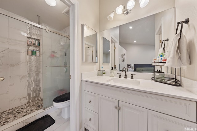 bathroom featuring vanity, toilet, and a shower with door