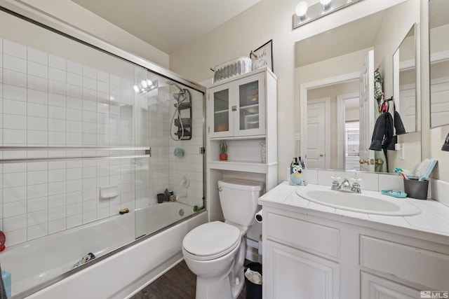 full bathroom with toilet, vanity, shower / bath combination with glass door, and hardwood / wood-style flooring