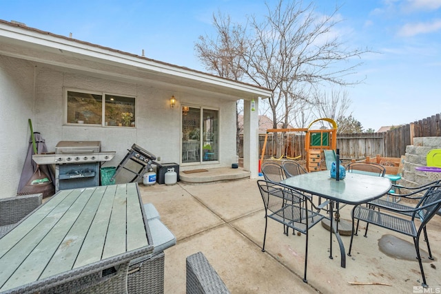 view of patio / terrace with area for grilling and a playground