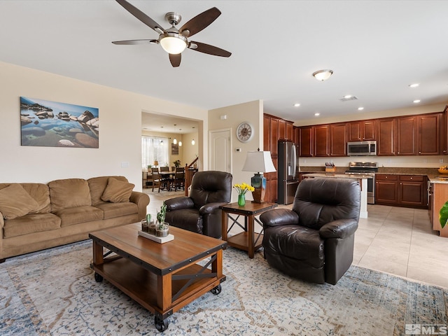 living room with ceiling fan and light tile patterned floors