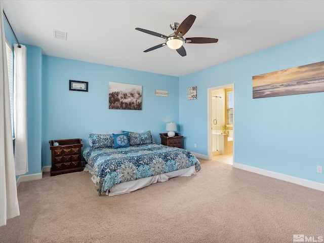 carpeted bedroom with ceiling fan and connected bathroom