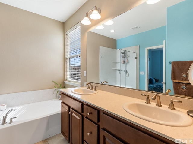 bathroom featuring vanity, separate shower and tub, and tile patterned floors