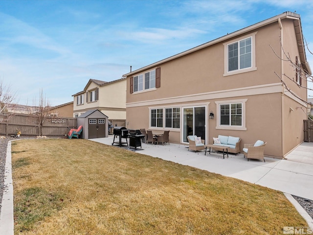 back of property with a yard, a patio area, outdoor lounge area, and a storage unit