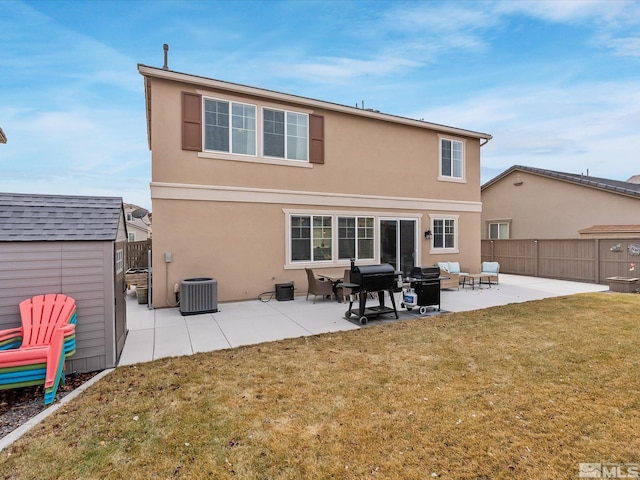 back of property with a storage shed, a yard, central AC unit, and a patio