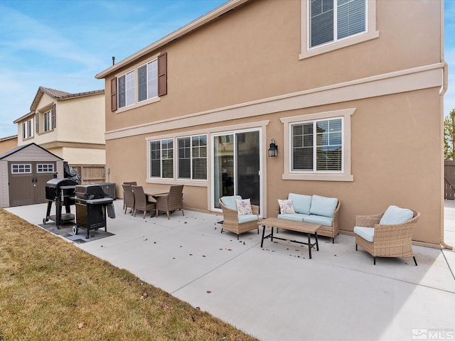 back of property featuring a storage shed, an outdoor hangout area, and a patio