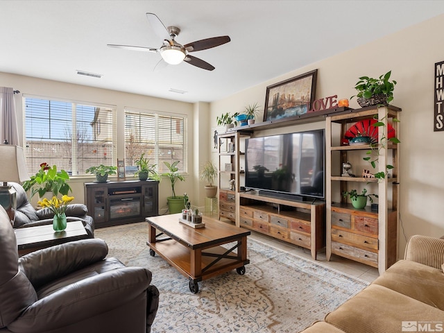 tiled living room featuring ceiling fan