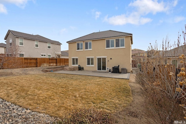 rear view of house featuring a yard, a patio area, and central air condition unit