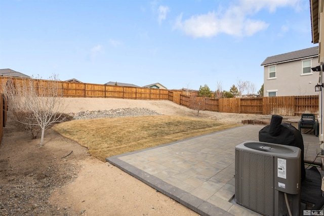 view of yard with central AC unit and a patio area