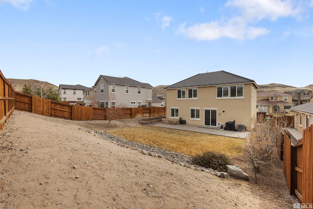 rear view of property featuring a patio area