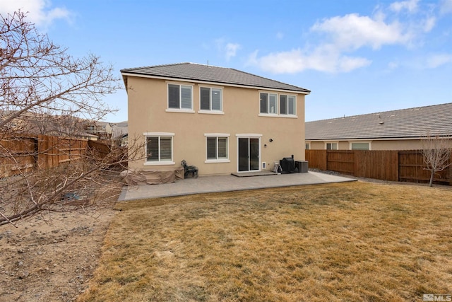 rear view of house with a yard, a patio, and central air condition unit