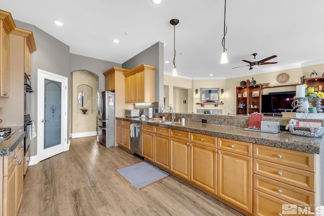 kitchen featuring pendant lighting, sink, ceiling fan, stainless steel appliances, and light hardwood / wood-style floors