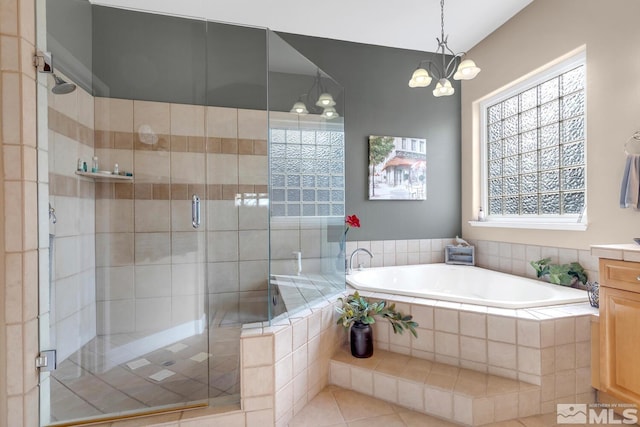 bathroom featuring vanity, tile patterned floors, shower with separate bathtub, and an inviting chandelier