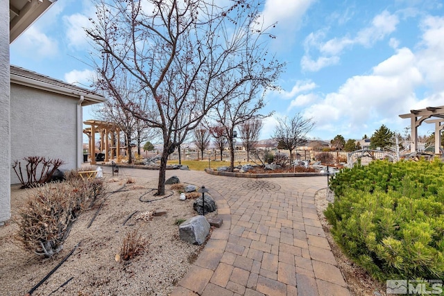 exterior space with a patio area and a pergola