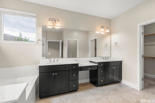 bathroom with tile patterned floors, vanity, and a bath