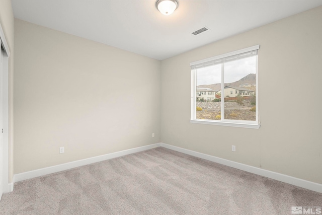 unfurnished room with light colored carpet