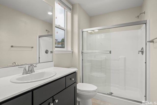 bathroom with vanity, toilet, and walk in shower