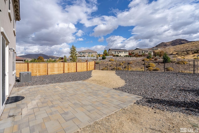 view of patio / terrace with cooling unit and a mountain view