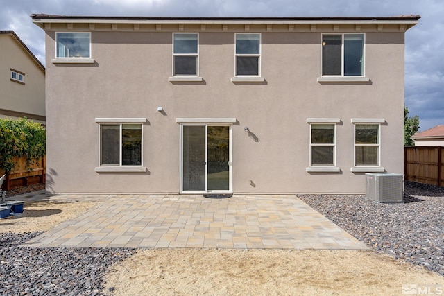 back of property with a patio area and central air condition unit