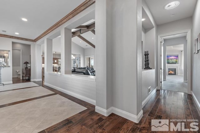 corridor with crown molding, hardwood / wood-style flooring, and lofted ceiling with beams