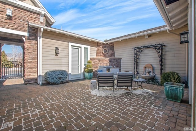 view of patio featuring an outdoor fireplace